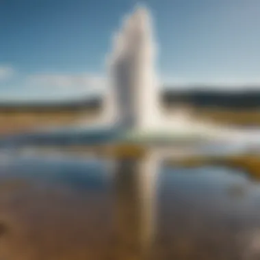 Panoramic view of a Yellowstone geyser against a clear summer sky