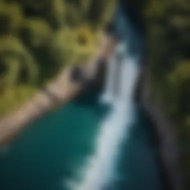 An aerial view of a waterfall flowing into a tranquil pool, showcasing the vibrant colors of the surrounding landscape.